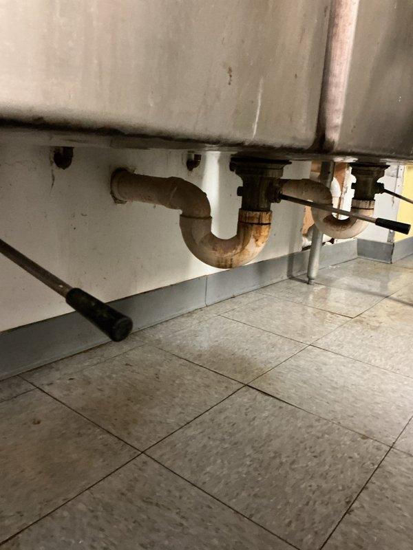 Responded to leak repair service call where customer had opened wall to expose a broken 3/4" copper pipe damaged by freezing. Replaced the damaged copper section, but upon restoration of water service, multiple additional leaks were detected within the wall cavity. Documentation with photos shows aged copper piping with patina throughout the exposed area and significant wall damage requiring further repair. Additional service appointment needed to address all remaining leaks.