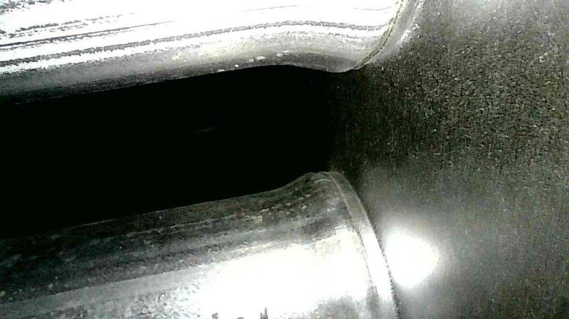 Performed furnace inspection and tune-up on an 8-year-old Goodman two-stage system with concentric venting. Removed debris (leaves and spiderwebs) from intake, relocated garden hose improperly placed across unit, and opened four partially/fully closed dampers to improve airflow. System now operating with good temperature split in both low and high fire modes.