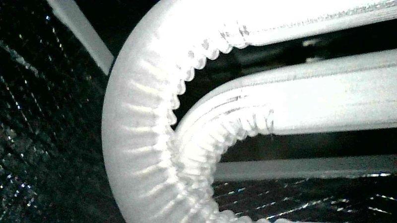 Performed furnace inspection and tune-up on an 8-year-old Goodman two-stage system with concentric venting. Removed debris (leaves and spiderwebs) from intake, relocated garden hose improperly placed across unit, and opened four partially/fully closed dampers to improve airflow. System now operating with good temperature split in both low and high fire modes.