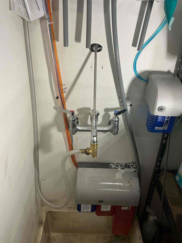 Successfully installed a new mop sink faucet to replace the old unit and added a stop and waste tee on the mop sink faucet. Installation required 2 hours of labor and included proper connection of water supply lines to the dual-handle wall-mounted fixture with appropriate valving for future service access.