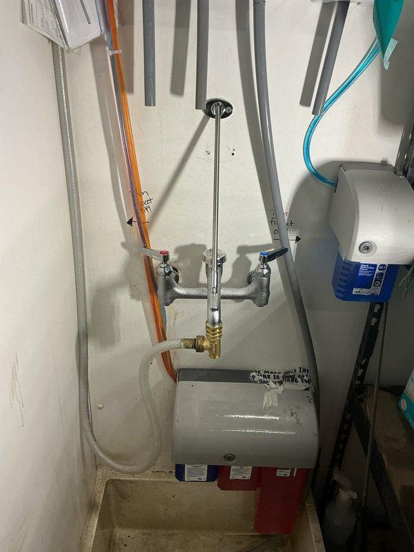 Successfully installed a new mop sink faucet to replace the old unit and added a stop and waste tee on the mop sink faucet. Installation required 2 hours of labor and included proper connection of water supply lines to the dual-handle wall-mounted fixture with appropriate valving for future service access.
