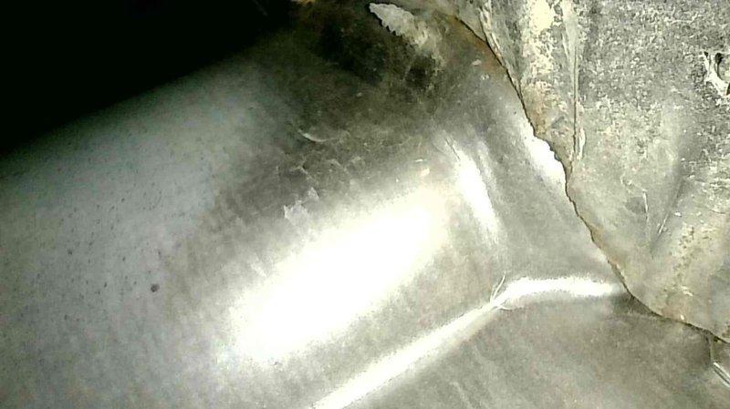 Performed annual furnace tune-up including cleaning of routine components and comprehensive system inspection. Heat exchanger was examined and found to be in acceptable working condition. Documentation photos were taken of heat exchanger showing early signs of surface rust and structural elements for maintenance records.