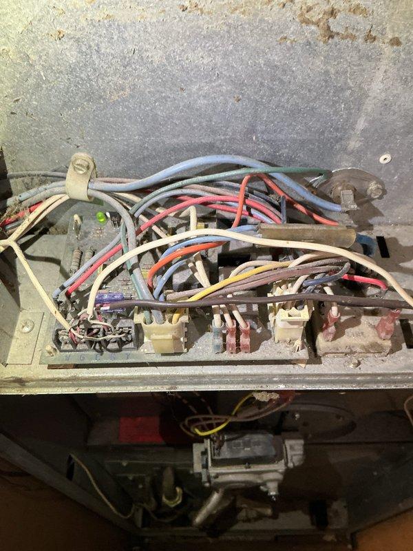 Responded to no heat service call for 29-year-old Evcon furnace. Diagnosed failed inducer draft motor and broken igniter. Replaced draft motor which restored proper operation of that component, but system remains non-operational due to damaged igniter that customer declined to have replaced. Visual inspection revealed significant dust accumulation on blower assembly and aging wiring in control compartment. Recommended complete system replacement due to age and condition.