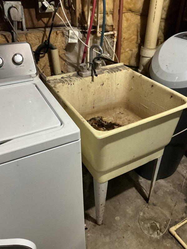 Removed and capped utility sink in basement to allow access for electrical panel replacement. Repaired leaking threaded joint on toilet drain line and replaced deteriorated toilet that was loose and rocking. All water supply lines were properly terminated and secured to prevent future leakage issues.