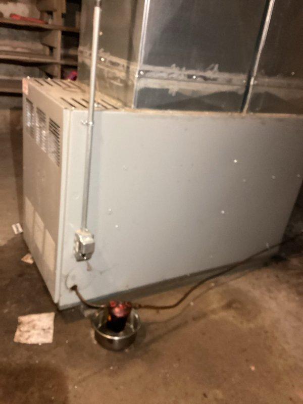 Responded to service call for oil furnace that failed to re-light after running out of fuel. Diagnosed heavily sooted system due to lack of maintenance; performed complete tune-up including cleaning of nozzle, chimney, and all clean-out ports. Successfully removed accumulated soot, replaced nozzle, and verified proper system operation despite tank shutoff and filter remaining frozen outside.