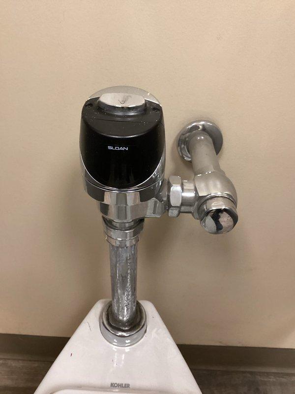 Responded to service call for automatic flush valve malfunction in women's restroom. Diagnosed broken flush valve with wires disconnected from motion sensor to solenoid. Restored toilet functionality temporarily, but replacement parts will be required for permanent repair.