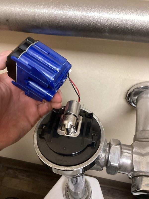 Responded to service call for automatic flush valve malfunction in women's restroom. Diagnosed broken flush valve with wires disconnected from motion sensor to solenoid. Restored toilet functionality temporarily, but replacement parts will be required for permanent repair.