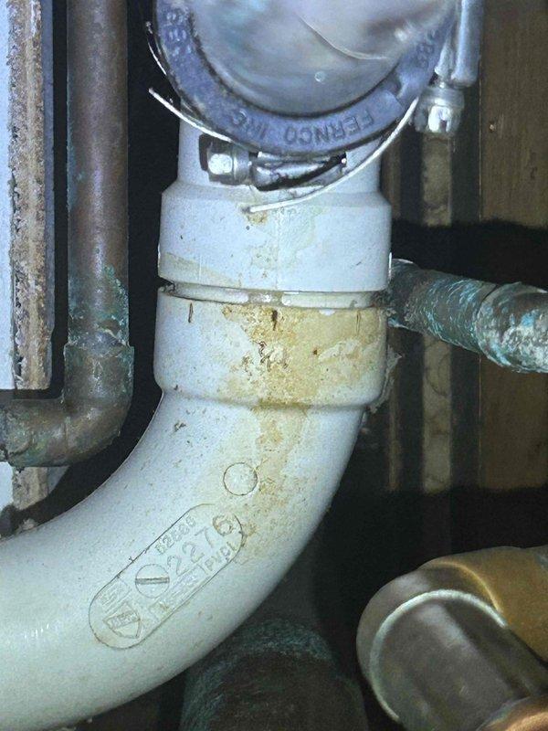 Responded to service call for reported boiler leak. Upon inspection, no active leakage was observed at the boiler; however, water staining was identified on the floor below a kitchen drain pipe. Diagnostic testing confirmed the source was a leaking PVC drain pipe connection from the kitchen sink above, not the boiler system. Recommended plumbing service to address the drain pipe issue.
