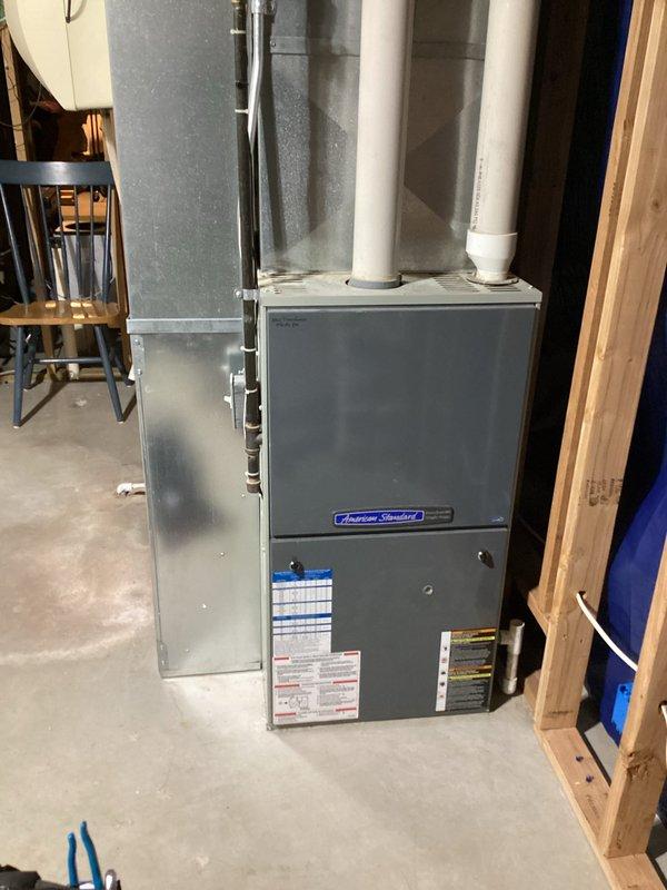 Responded to no heat call for American Standard furnace with intermittent ignition failure. Diagnosed and cleaned flame sensor, which resolved immediate issue. Inspection revealed small cracks in heat exchanger inlet and noisy inducer motor that may be affecting proper gas draw to igniter. Provided customer with replacement options for both furnace and water heater.