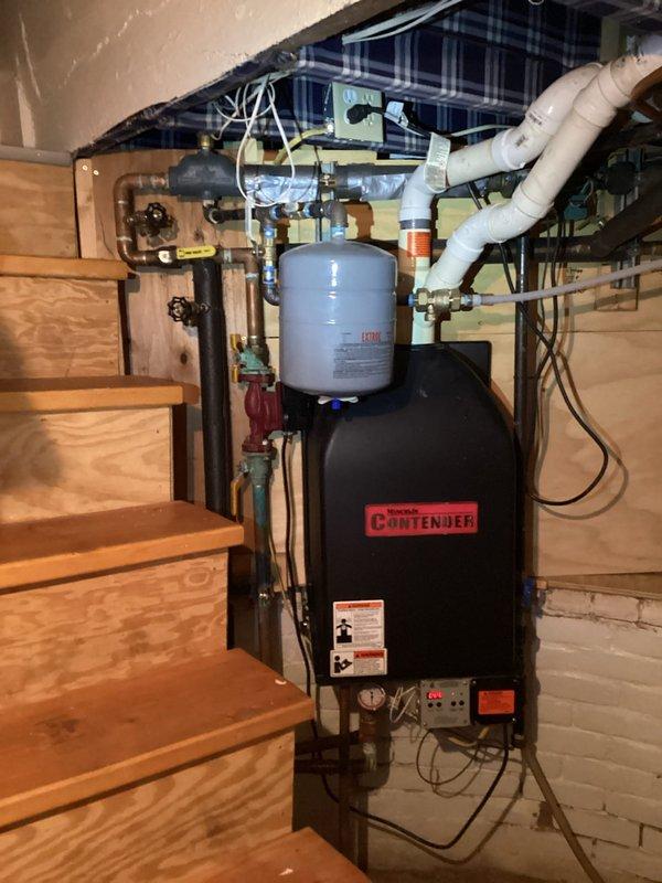 Responded to service call for non-functioning Weil-McLain Contender boiler displaying F09 error code (flame sensing failure). Removed and cleaned igniter and flame sensor, inspected heat exchanger, and successfully restored system operation. Recommended replacement of igniter and flame sensor along with heat exchanger cleaning to ensure continued reliability, though customer indicated intent to replace entire unit in spring.