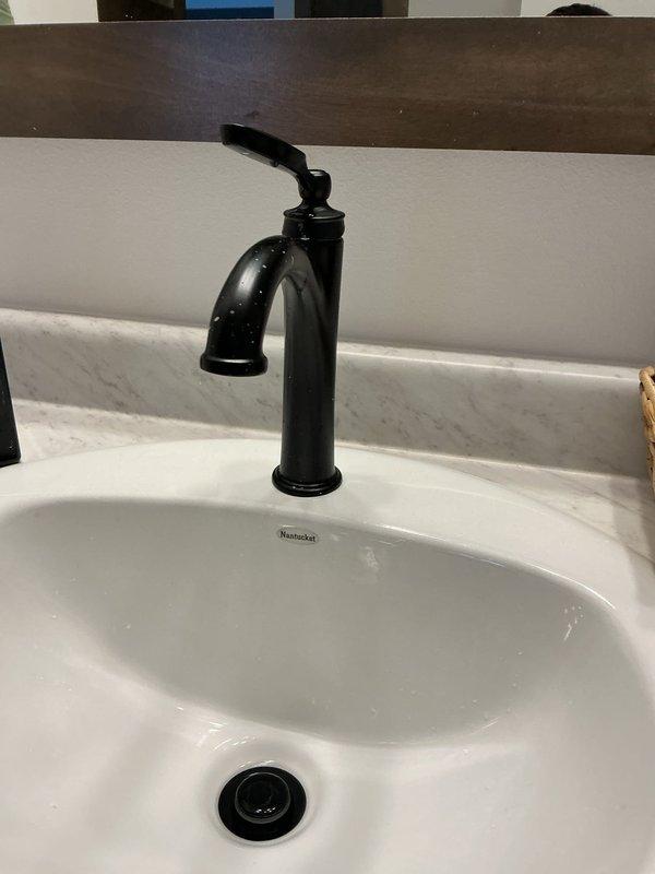 Conducted annual plumbing inspection on recently constructed home (built approximately four months ago). All plumbing systems and fixtures, including bathroom sink with Nantucket basin and matte black faucet, are in excellent working condition with properly installed P-trap drain assembly. Recommended future installation of water softener system for optimal long-term plumbing performance.