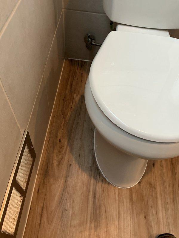 Responded to toilet leak issue at base. Diagnosed slow leak originating from failed wax ring seal. Performed complete toilet pull and reset with new wax ring to establish proper seal between toilet and waste pipe flange, eliminating the leak.