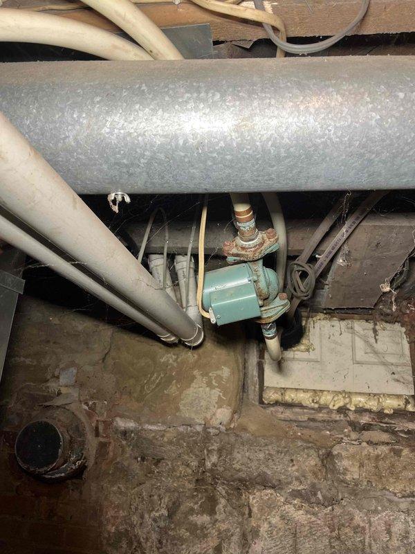 Responded to service call for an outdoor wood burner heating system with no heat supply to the residence. Diagnosed low water level causing airlock in the circulation system despite functioning pump. Restored proper operation by adding water to correct level, purging air from lines, and verifying circulation resumed with heat transfer to indoor coil. System returned to normal operation with water temperature at 180° and proper pressure maintained.