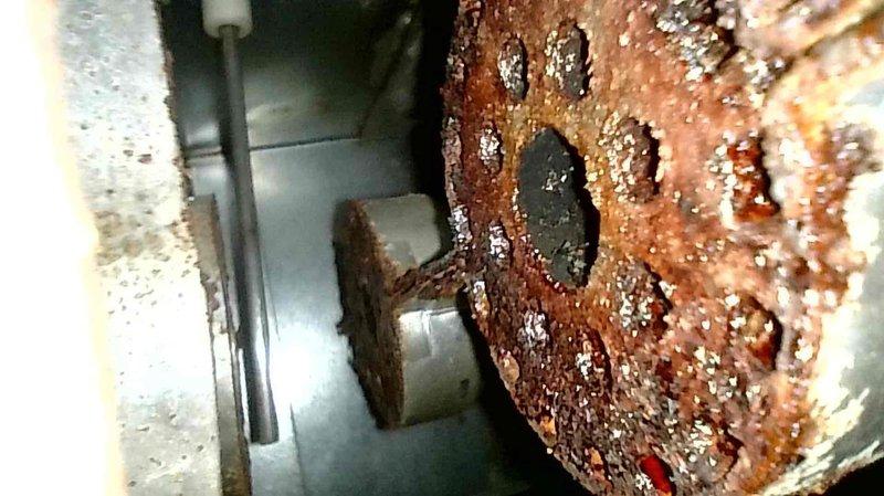 Serviced 2009 LP furnace with no heat complaint where blower motor was continuously running regardless of thermostat position. Diagnosed ignition failure code caused by tripped limit switch in inducer motor. Discovered severely rusted burners and secondary heat exchanger clogged with debris causing significant airflow restriction, which likely triggered the limit switch due to overheating. Reset system and restored temporary operation pending scheduled replacement of burners and cleaning of secondary heat exchanger.