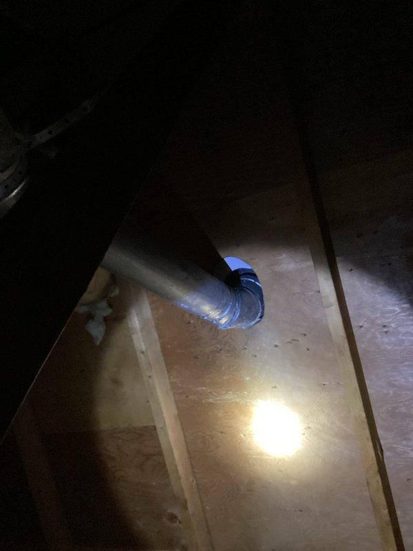 Inspected water heater venting system in attic and identified flue pipe detachment at 45-degree connection point at roof penetration. Documented condition with photos showing exposed metal ductwork with compromised blue connection collar. Scheduled follow-up service with heating technicians to properly reconnect and secure the flue system.