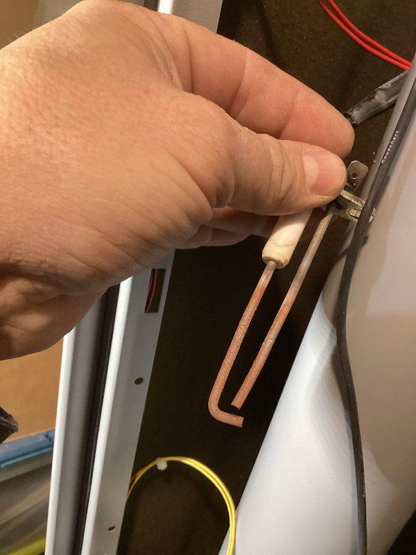 Responded to service call for non-functioning 13-year-old boiler displaying lockout due to failed ignition. Inspection revealed a pitted ignitor with significant wear. Reset unit and successfully restored operation, verifying proper system circulation. Recommended replacement of the ignitor to prevent future failures.