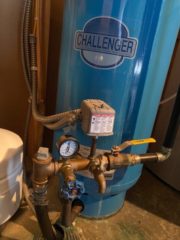 Diagnosed pressure tank system exhibiting short-cycling (5-6 minute intervals for approximately 10 seconds) with no gauge movement. After isolating the house with the main valve, determined pump continued to activate, indicating a leak on the well side of the system. Customer referred to well company for specialized service.