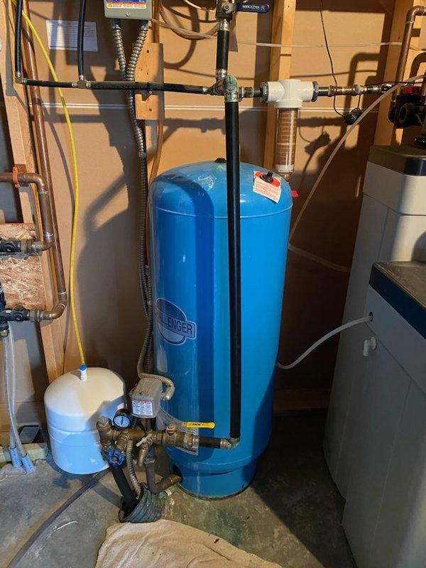 Diagnosed pressure tank system exhibiting short-cycling (5-6 minute intervals for approximately 10 seconds) with no gauge movement. After isolating the house with the main valve, determined pump continued to activate, indicating a leak on the well side of the system. Customer referred to well company for specialized service.