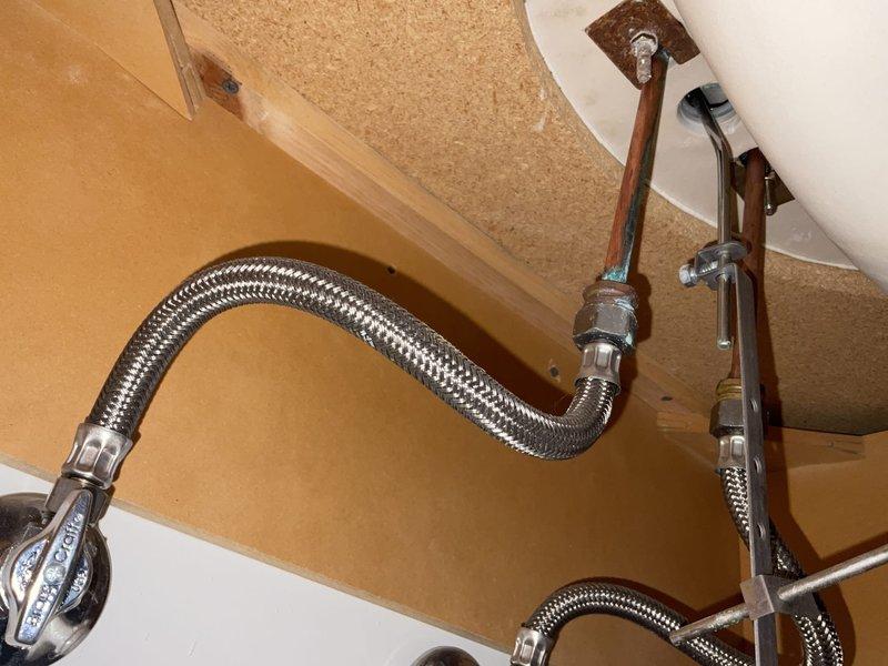 Conducted comprehensive plumbing inspection of residential property, examining under-sink supply lines with shut-off valves and attic PVC drainage system. All connections were verified secure with no signs of leaks or deterioration; supply lines and fixtures were confirmed in good working condition with proper installation.