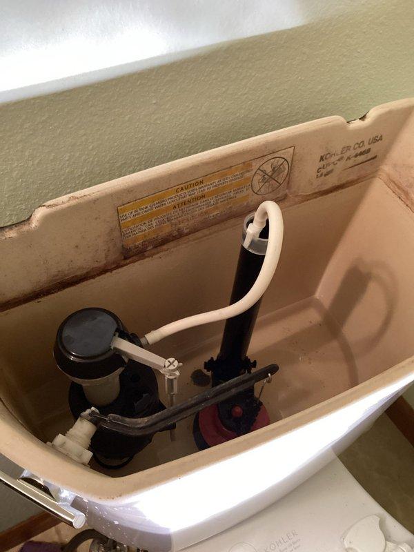 Responded to warranty service call for a toilet leaking from previous repair. Upon inspection, determined the original issue was misdiagnosed - the fill valve wasn't shutting off properly and the universal overflow tube was set too high, causing water to leak through the trip lever. Replaced the fill valve and trimmed the overflow tube to proper height, resolving the leak.