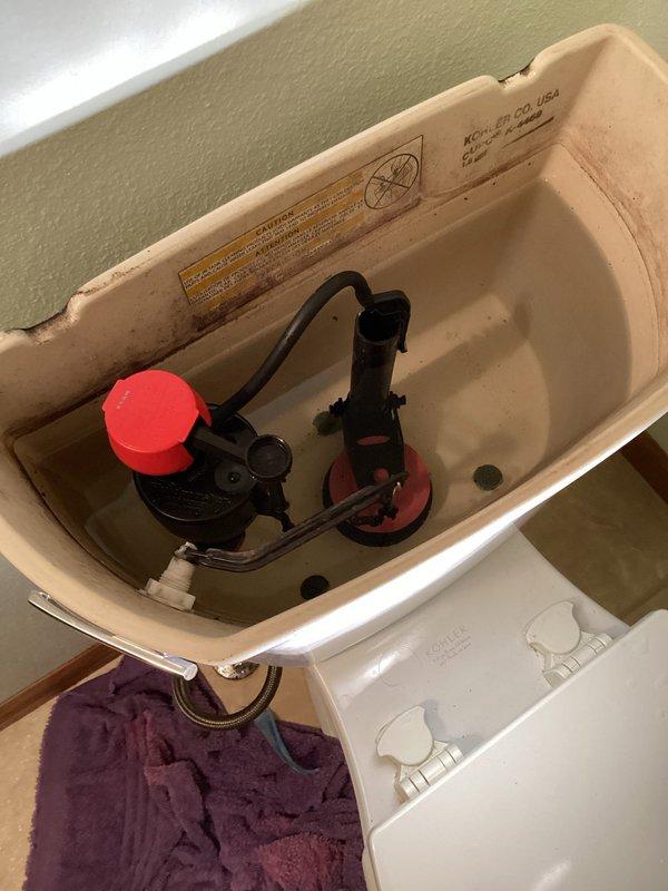 Responded to warranty service call for a toilet leaking from previous repair. Upon inspection, determined the original issue was misdiagnosed - the fill valve wasn't shutting off properly and the universal overflow tube was set too high, causing water to leak through the trip lever. Replaced the fill valve and trimmed the overflow tube to proper height, resolving the leak.