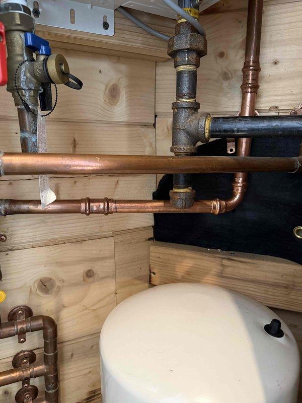 Repaired 3/4" copper cold water line in utility room of tiny home that had frozen and burst. This was the second occurrence in the same general area, with current failure approximately one foot from previous repair. Replaced damaged section of pipe and verified proper operation of the plumbing system.