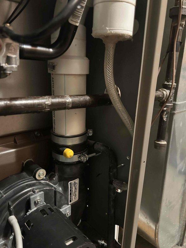 Performed comprehensive maintenance on two furnaces: newer Lennox unit (4-5 years old) and older Evcon model (20 years old). On the Lennox, reattached disconnected water exhaust pipe using PVC cement for permanent connection. For the Evcon furnace, replaced cracked drain hose and broken barbed fitting with new 3/8" vinyl tubing, secured with silicone sealant. Both units were tested and confirmed to be operating within specifications.