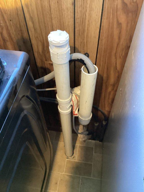 Responded to service call for kitchen sink backup and leak under sink when laundry was in use. Diagnosed cross-connection between kitchen and laundry drain systems causing simultaneous backups. Snaked kitchen drain line to clear obstruction and inspected laundry drain configuration, confirming proper venting and drainage pathway to prevent future backups.