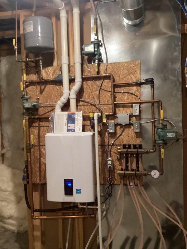 Performed routine maintenance on 4-year-old Navien boiler system. Cleaned components, inspected electrical connections, and verified proper operation of both basement and garage heating zones with good circulation. Customer reported concerns about backflow preventer vent leaking; however, home water supply was shut off during service, preventing leak verification. Provided estimate for backflow preventer replacement.