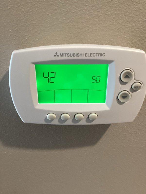 Diagnosed Mitsubishi mini-split system displaying error code 42-50 (overcurrent trouble) at Dimensions Living Facility. Upon inspection, found compressor was grounded out indicating internal compressor failure. Will obtain pricing for replacement compressor, though noted this is a large commercial system which may require specialized service.