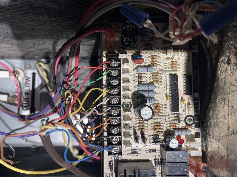 Responded to a commercial daycare facility for no heat complaint in classroom. Diagnosed blown fuse on air handler control board caused by electrical wiring shorting against copper refrigerant lines in the heat pump. Repaired by insulating and taping exposed wires to prevent future contact. Reset outdoor temperature lockout from disabled setting to 25°F to prevent heat pump operation in extreme cold conditions. System now operating normally.