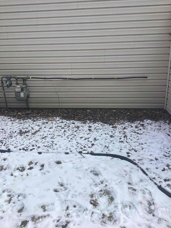 Completed installation of new 1/2-inch gas line running to the meter per sold estimate, including capping of the old gas line in the wall. Connected new gas line to exterior regulator assembly with proper fittings, ensuring secure installation to the building's exterior wall.