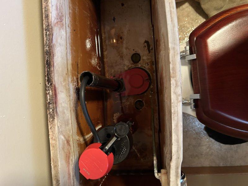 Replaced faulty fill valve and flapper in upstairs toilet that was continuously running and had caused overflow damage to the downstairs ceiling. Performed visual inspection of associated plumbing components and water heater system to ensure proper operation after repair.