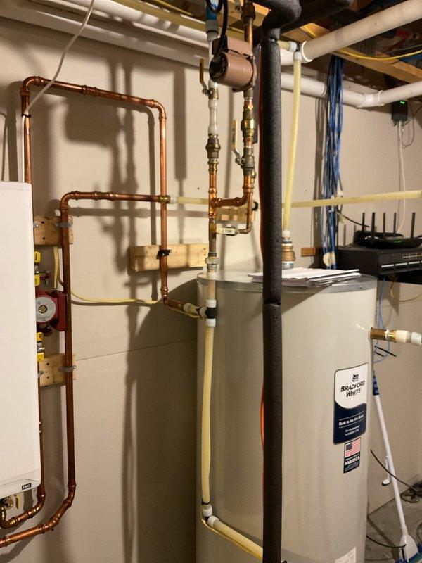 Replaced IBC fan assembly on on-demand water heater under warranty (1.5 hours labor). Unit was short cycling upon arrival; installation of new fan motor completed successfully. Identified improper plumbing configuration where cold water feed line is positioned below hot water lines; submitted follow-up form requesting plumbing corrections to resolve this installation issue.