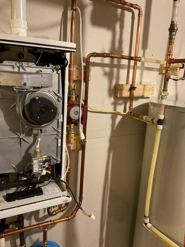 Replaced IBC fan assembly on on-demand water heater under warranty (1.5 hours labor). Unit was short cycling upon arrival; installation of new fan motor completed successfully. Identified improper plumbing configuration where cold water feed line is positioned below hot water lines; submitted follow-up form requesting plumbing corrections to resolve this installation issue.