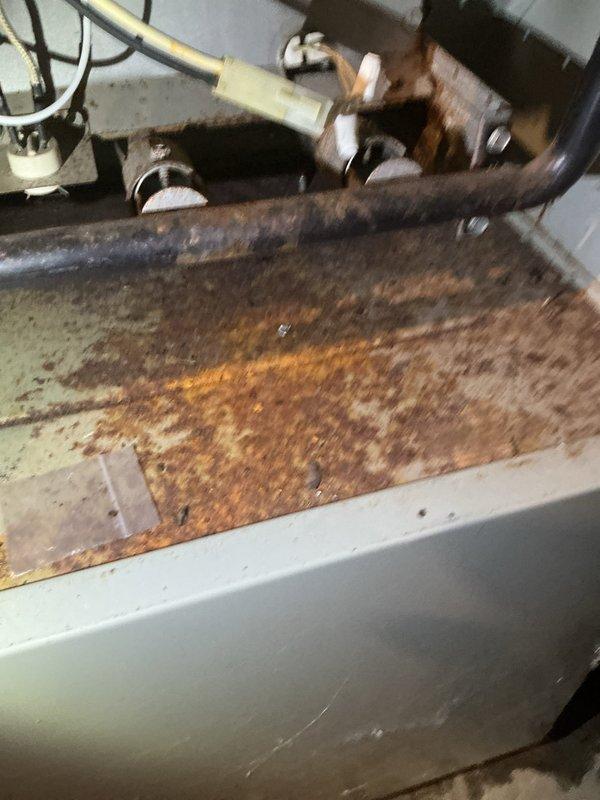 Completed furnace maintenance inspection on a 35-year-old natural gas system. Discovered severely deteriorated heat exchanger with extensive rust damage and corrosion, indicating long-term moisture exposure. Discussed replacement options with customer and scheduled follow-up with comfort advisor.