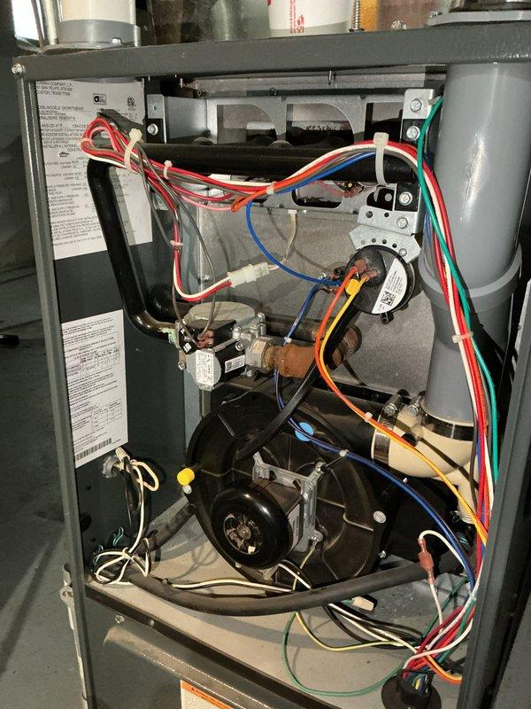 Responded to no-heat call for 17-year-old furnace with failed thermostat. Diagnostic inspection revealed critical safety issues including failing inducer draft motor and heat exchanger with perforated tubes. Determined unit unsafe for operation and recommended complete system replacement.