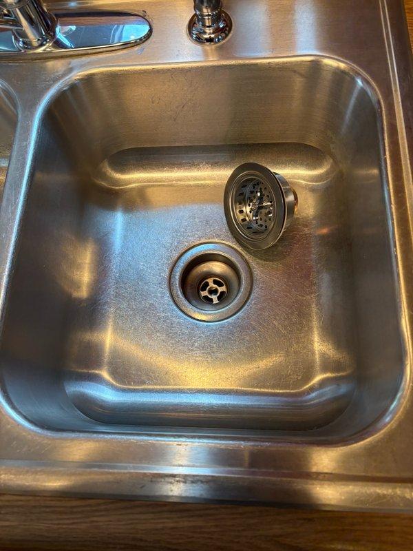 Replaced kitchen sink basket strainer as requested by customer, ensuring proper installation and verifying no leaks. Additionally, provided education on heat pump water heater seasonal operation and addressed customer's concerns regarding their water treatment system, resulting in customer satisfaction with both the repair and information provided.