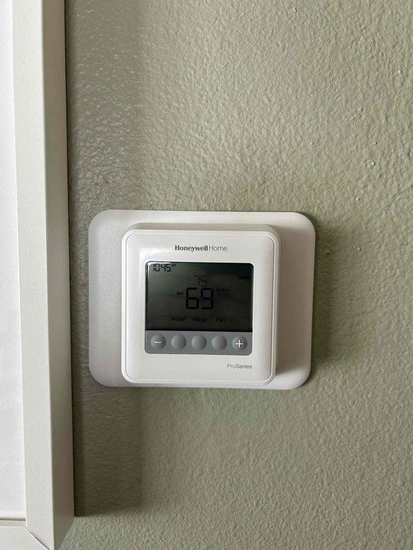 Responded to service call for malfunctioning thermostat. Diagnosed non-responsive controls after homeowners returned to residence. Removed existing thermostat, installed new Honeywell Home ProSeries T4 thermostat, connected appropriate wiring to terminal block, and verified proper heating system operation. Demonstrated thermostat functionality to homeowner before completing service.