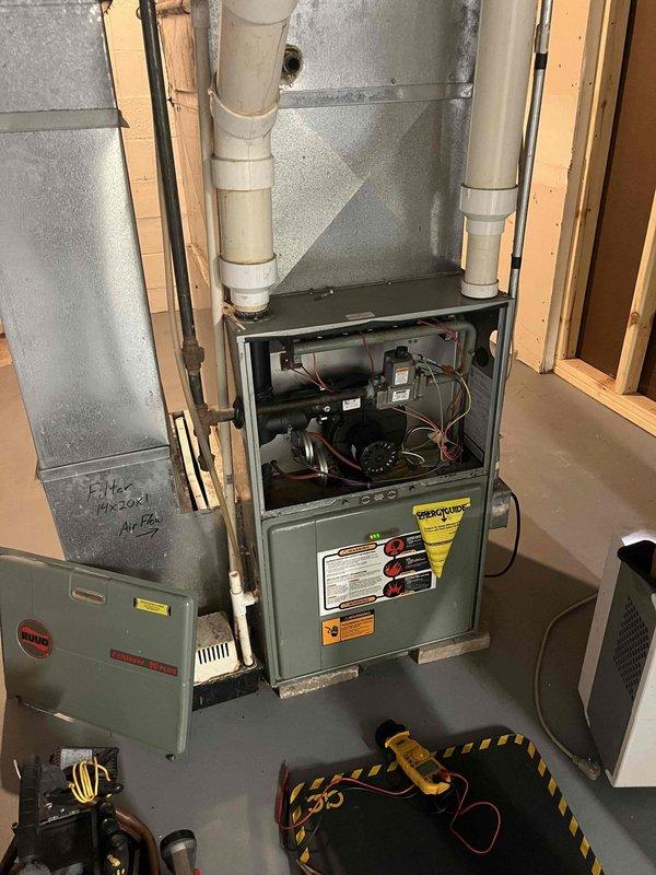 Performed routine furnace preventative maintenance inspection and identified a cracked flue collar with active water leakage, which was temporarily sealed with caulk. Inspection also revealed failing blower bearings requiring replacement. Heat exchanger and all other components were verified to be in working condition and operating within specifications.