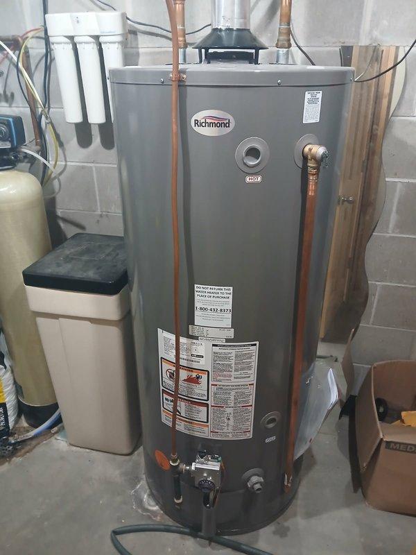 Performed a comprehensive flush on an 80-gallon Richmond gas water heater, running the procedure for approximately 30 minutes to remove sediment buildup and restore optimal efficiency. During service, inspected the burner assembly which showed proper blue flame pattern and no signs of malfunction. Visual inspection confirmed all connections and components were in good working condition with no leaks detected.