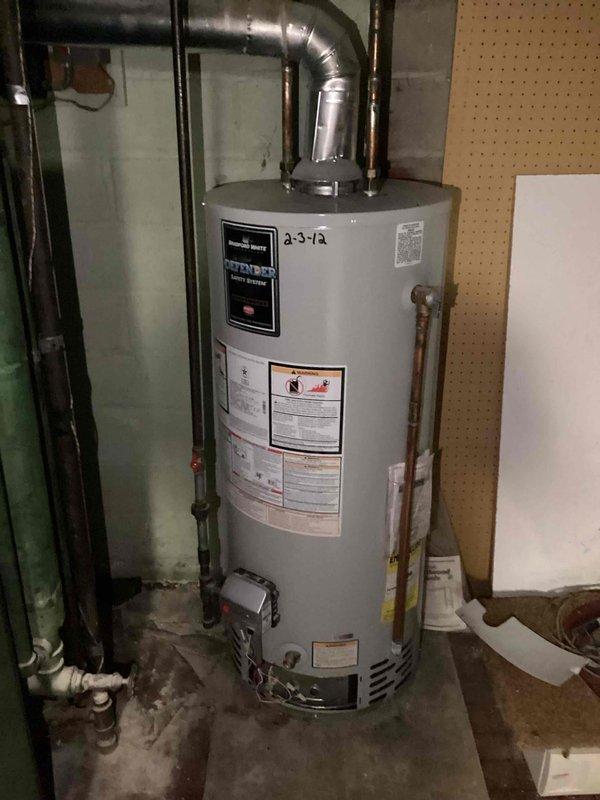 Diagnosed a non-functioning Bradford White water heater with no error codes displayed. Inspection revealed an internal tank leak, requiring full unit replacement. Successfully installed new Defender model water heater with proper ventilation and connection to existing copper and PVC piping systems.