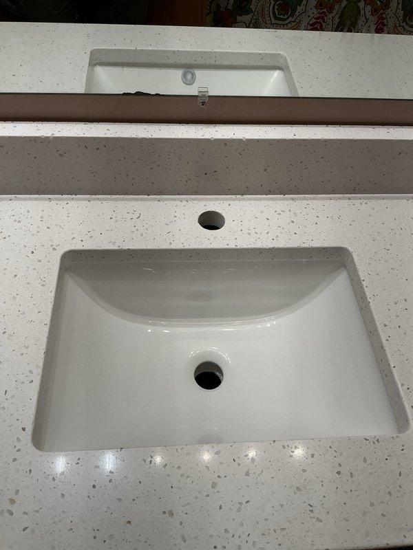 Reconnected kitchen sink and bathroom vanity faucet following countertop installation. Replaced non-functional garbage disposal with new unit and installed new kitchen and bathroom vanity faucets, ensuring proper connection and operation of all plumbing components.