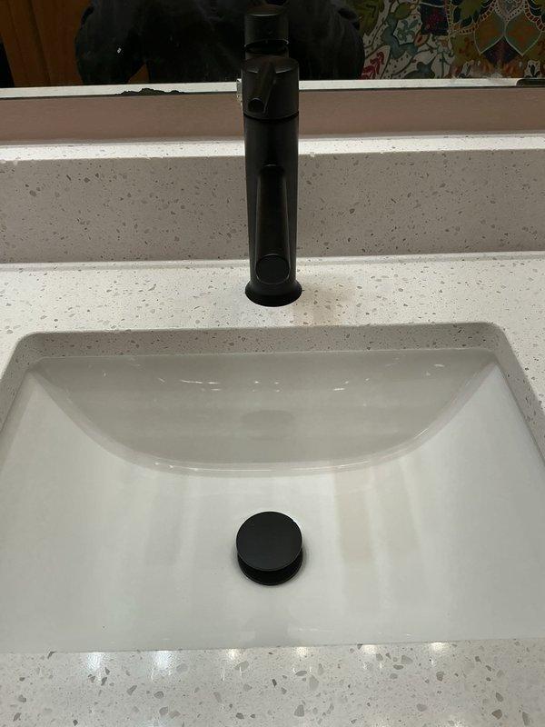 Reconnected kitchen sink and bathroom vanity faucet following countertop installation. Replaced non-functional garbage disposal with new unit and installed new kitchen and bathroom vanity faucets, ensuring proper connection and operation of all plumbing components.