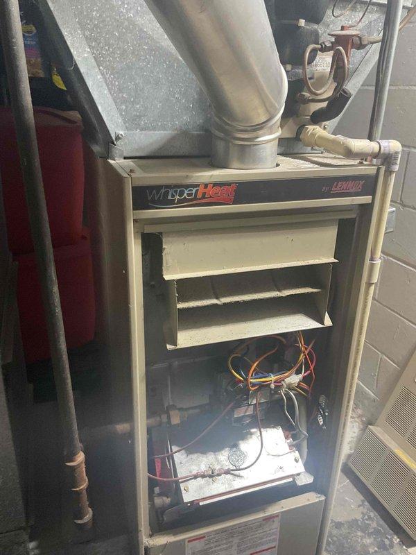 Responded to no-heat call for 25+ year old Lennox WhisperHeat furnace. Diagnosed multiple critical failures including compromised heat exchanger, intermittent pilot outages, and gas valve malfunction causing the unit to blow cold air. Replaced furnace due to age and safety concerns.