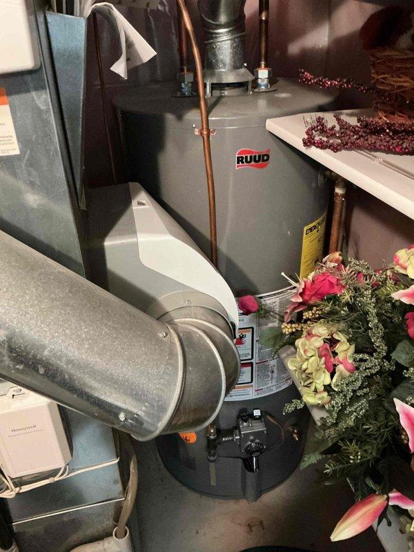 Responded to service call for 18-year-old Carrier AC unit that wouldn't shut off via thermostat. Diagnosed shorted crankcase heater affecting compressor operation, which was verified by removing heater from circuit. Also inspected secondary heat exchanger and noted early signs of moisture intrusion behind the component. Scheduled follow-up with service advisor to address repairs.