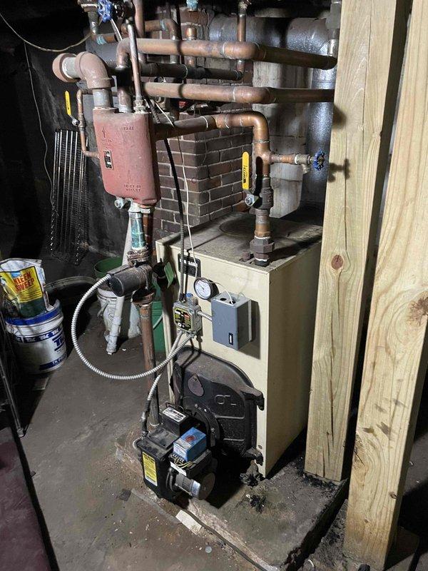 Performed oil furnace tune-up and safety check including fire side cleaning, nozzle replacement, and oil filter replacement on commercial bar line. Diagnostic testing revealed significant negative building pressure when commercial range hood operates, causing combustion air starvation and exhaust backdrafting through multiple pathways. Recommended upgrading to sealed combustion gas boiler to resolve ongoing ventilation issues.