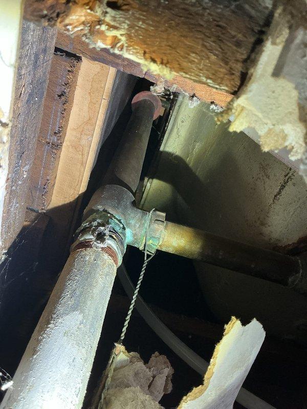 Responded to service call for intermittent water discharge from drainage pipe in basement. Diagnosed issue with improperly secured drain lines where they connect to standpipes. Extended pipes slightly and installed J-hook to secure lines to wall, preventing future water discharge incidents.