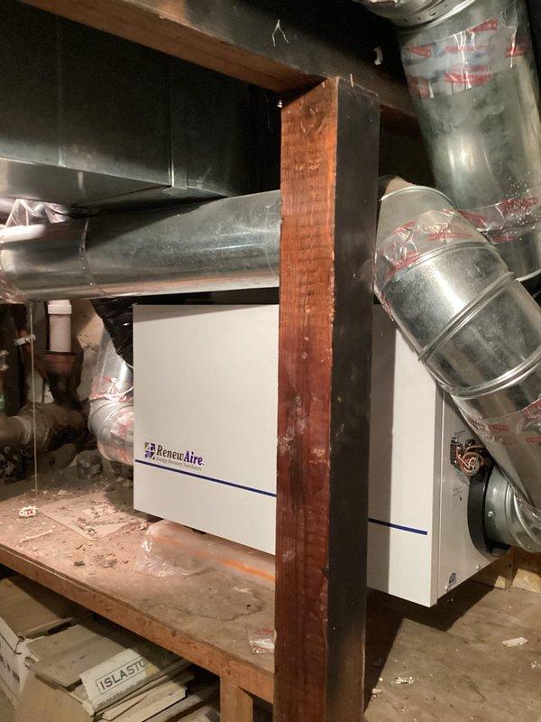Diagnosed multiple issues with the boiler system including a bypassing zone valve causing overheating in one room, non-functioning pressure gauge, immobile fill valves, leaking pressure relief valve, and potentially waterlogged expansion tank. Documented system components including control modules mounted on copper pipes and the RenewAire unit with associated ductwork for comprehensive repair estimation.