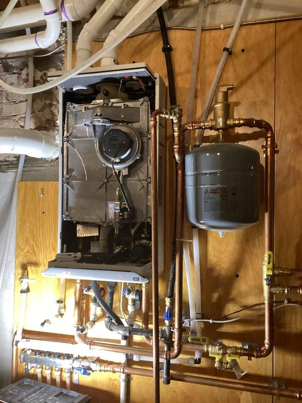 Responded to a no-heat call for a combination boiler that provides both domestic hot water and in-floor heating. Upon inspection, determined the unit was simply turned off at the control board, likely accidentally by the homeowner while working above the unit. Power was restored to the system, and proper operation was verified for both heating and hot water functions.